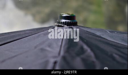 A top of a black umbrella in a sunny day. Stock Photo