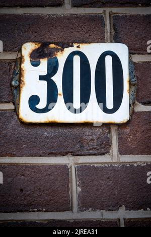 Number three hundred sign on brick wall Stock Photo
