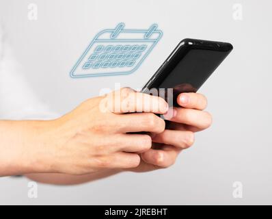 Woman using planner calendar on phone. Mobile daily planning app. Hands with smartphone. Day schedule concept. High quality photo Stock Photo