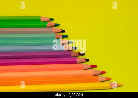 color pencils on green background. Copy space Stock Photo