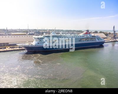 Cruise vessel Balmoral maiden call in Liepaja during Baltic sea summer cruise 2022.  Vessel approaching breakwater of Liepaja port. Aerial drone photo Stock Photo