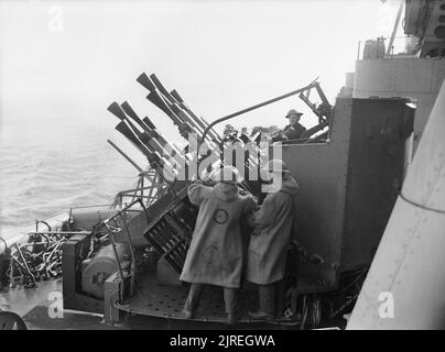 On board HMS Howe during WWII, Commodore Earl Howe, RNVR, stands with ...