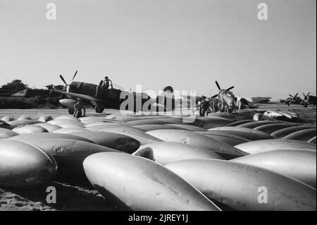 Royal Air Force Operations in the Far East, 1941-1945. 37-gallon long-range drop-tanks amassed next to the Republic Thunderbolt Mark IIs of No. 30 Squadron RAF, as they are readied for a sortie at Cox's Bazaar, India. Stock Photo