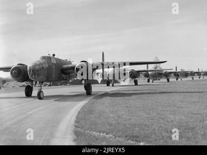 Royal Air Force- 2nd Tactical Air Force, 1943-1945. North American Mitchell Mark IIs of No. 98 Squadron RAF taxying along the perimeter track at Dunsfold, Surrey, for a morning raid on targets in northern France. Stock Photo