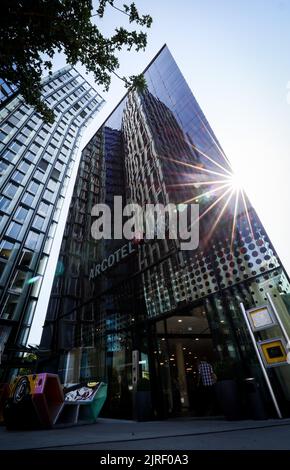 Hamburg, Germany. 24th Aug, 2022. The Dancing Towers are reflected in the facade of a hotel on the Reeperbahn in St. Pauli. Three people who were guests at the hotel are in hospital after allegedly taking drugs together. One 22-year-old died. Credit: Christian Charisius/dpa/Alamy Live News Stock Photo