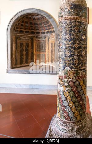 Ancient pillar and wall niche decorated with colorful mosaics Stock Photo