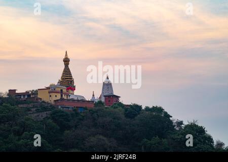 A bright sunset sky over the Swayambhunath Stupa Temple in Kathmandu, Nepal Stock Photo