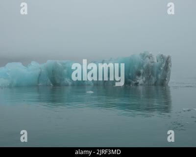 Huge iceberg from a melting glacier in the arctic. The icy landscape of the arctic nature. Spitsbergem, Norway. Stock Photo