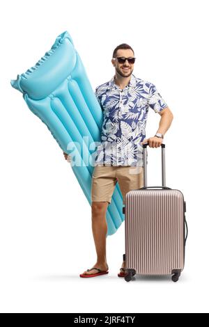 Full length portrait of a man holding an inflatable mattress and a suitcase isolated on white background Stock Photo