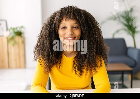 Web cam view of young adult woman having a virtual video call at home office Stock Photo