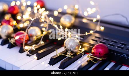Piano keyboard with Christmas garland close up Stock Photo