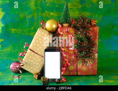 Christmas shopping online.Buying christmas  presents using smartphone.Gift boxes and phone.Free copy space Stock Photo
