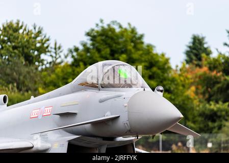 RAF Typhoon jet fighter plane at London Southend Airport for airshow displays. Front, nose, with glowing green HUD head up display. Pilot in cockpit Stock Photo