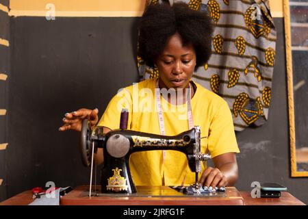 female african tailor sewing with her machine Stock Photo