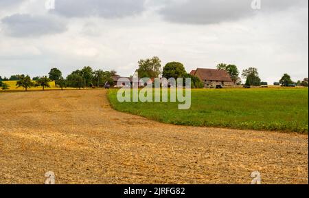 Stormy scenery around a small farm in Hohenlohe, an area in Southern Germany at late summer time Stock Photo