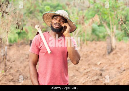 african farmer making a phone call Stock Photo