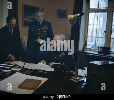 The Royal Air Force during the Second World War- Personalities Air Chief Marshal Sir Arthur T Harris, Commander in Chief of Royal Air Force Bomber Command, discussing an operation with the Senior Air Staff Officer, Air Vice Marshal R D Oxland, CB, CBE, and Mr M T Spence, OBE. Stock Photo