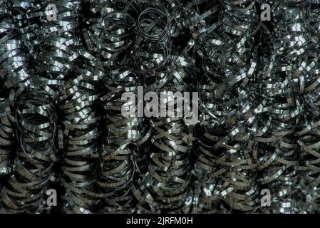 steel tangled spiral metal fibers background, macro photography close-up Stock Photo
