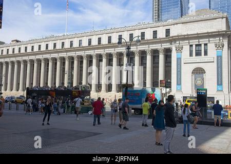 New York, NY, USA - Aug 23, 2022: The newly refurbished Moynihan Train Station on Eighth Ave with a tour bus in the foreground Stock Photo