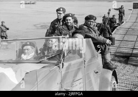 Airborne troops cross back over the Rhine in a captured German Kubelwagen car, March 1945. Airborne troops cross back over the Rhine in a captured German Kubelwagen car, 24 - 25 March 1945. Stock Photo