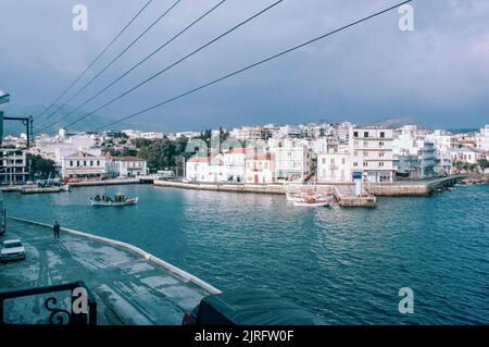 Agios Nikolaos port in Crete, the largest and most populous of the Greek islands, the centre of Europe's first advanced civilisation. March 1980. Archival scan from a slide. Stock Photo