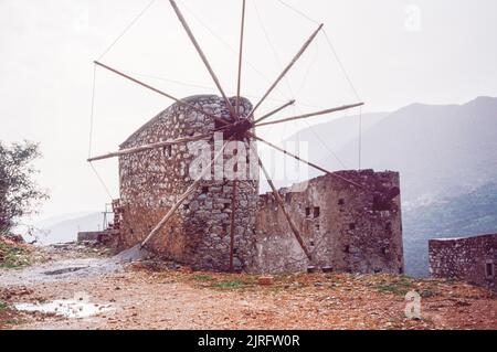 Typical windmill in Crete, the largest and most populous of the Greek islands, the centre of Europe's first advanced civilisation. March 1980. Archival scan from a slide. Stock Photo