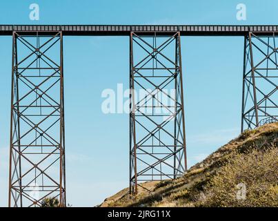 A tall train bridge viaduct engineered with iron steel trusses and beams for a strong structure Stock Photo