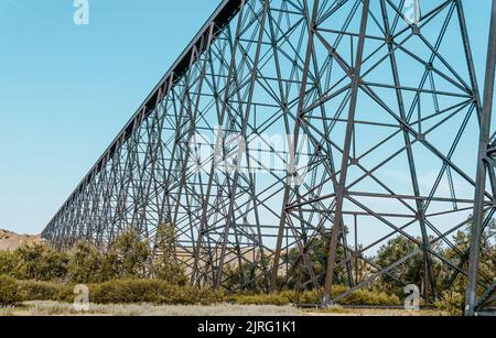 A tall train bridge viaduct engineered with iron steel trusses and beams for a strong structure Stock Photo