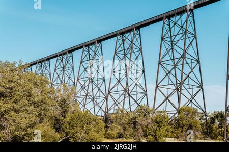 A tall train bridge viaduct engineered with iron steel trusses and beams for a strong structure Stock Photo