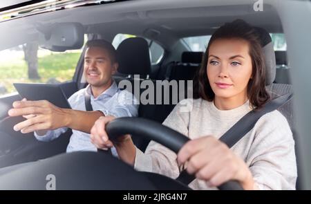 woman and driving school instructor in car Stock Photo