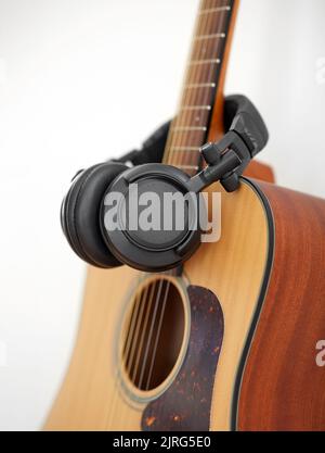 close up of acoustic guitar and headphones Stock Photo