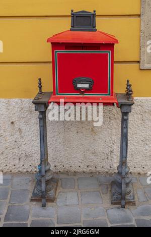 Historic Red Mail Box With Iron Legs at Street in Budapest Hungary Stock Photo