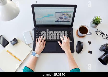 woman with video editor program on laptop at home Stock Photo