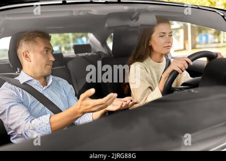 car driving school instructor teaching woman Stock Photo