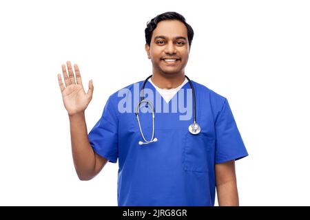 doctor or male nurse with stethoscope waving hand Stock Photo