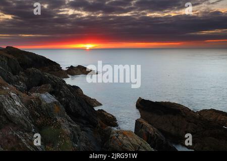 Sun Setting over the sea at Point Lynas, Anglesey, North Wales, UK. Stock Photo