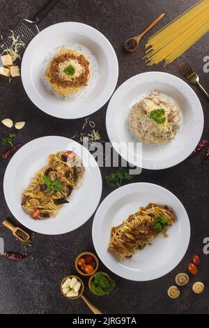 Several italian pasta spaghetti with bolognese meat sauce and parmesan on texture table. Close up Stock Photo