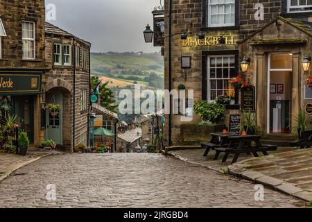 The cobbles at the top of Main Street, Haworth, West Yorkshire. Haworth is famous as the home of the Bronte sisters. Stock Photo