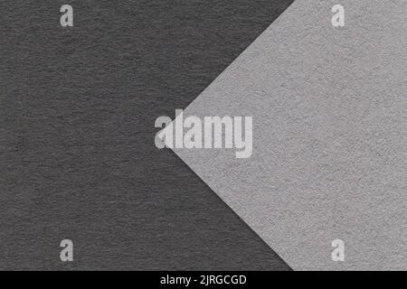 Texture of gray and black paper background, half two colors with arrow, macro. Structure of dense craft grey cardboard. Felt abstract backdrop closeup Stock Photo