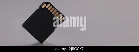 Black sd memory card, compact card with gold colored connectors Stock Photo