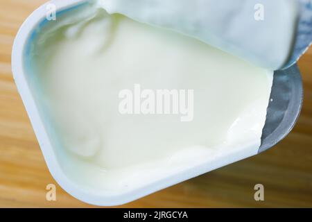 fresh yogurt in a plastic container close up  Stock Photo