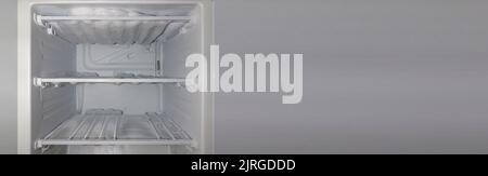 Refrigerator with a lot of frozen ice on the shelves. Stock Photo