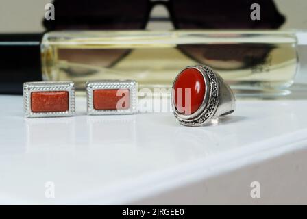 men spiritual stone ring isolated on white macro focus blurry background red coral gemstone closeup Stock Photo