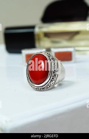 men spiritual stone ring isolated on white macro focus blurry background red coral gemstone closeup Stock Photo