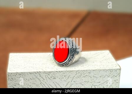 men spiritual stone ring isolated on white macro focus blurry background red gemstone closeup Stock Photo
