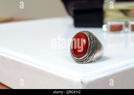 men spiritual stone ring isolated on white macro focus blurry background red gemstone closeup Stock Photo