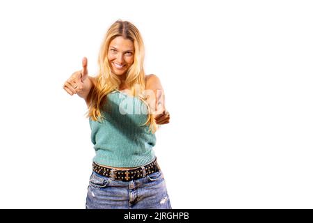 Motivated and smiling rocker girl gives a thumbs up as a sign of satisfaction. Stock Photo