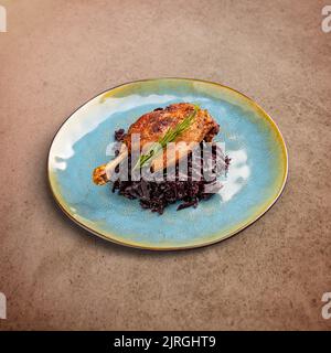 Grilled confit duck legs served with braised red cabbage Stock Photo