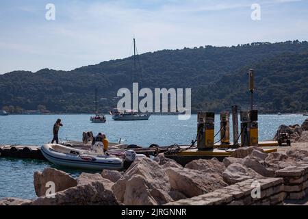 Boat filling up at harbour fuel station, Italy Stock Photo