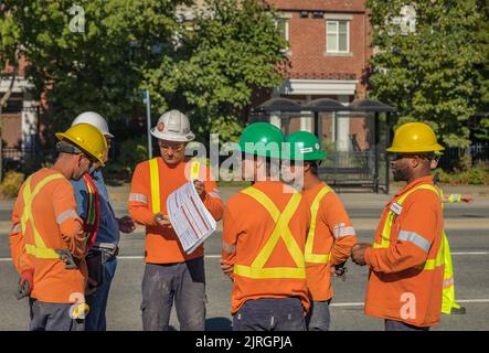 Road worker construction. Road workers inspecting construction. Engineer worker tablet working on site road construction. Men architecture builder bui Stock Photo